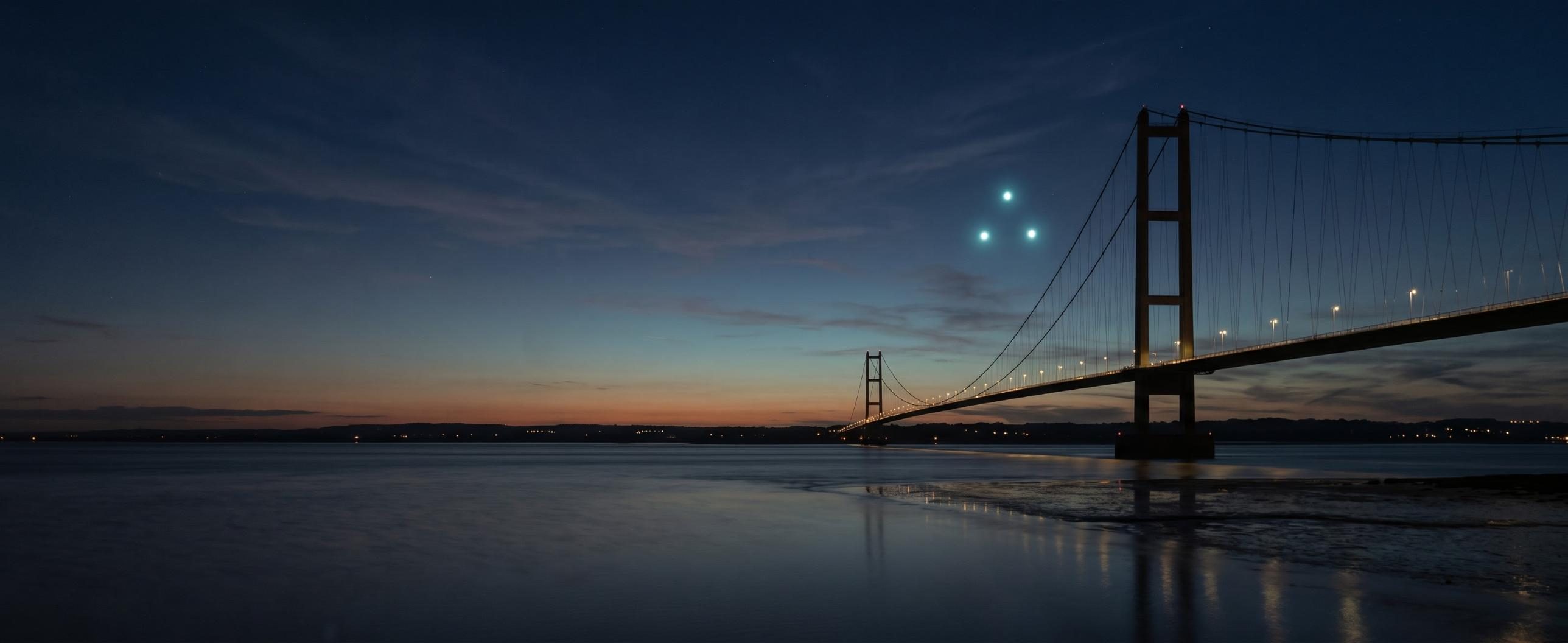 Three lights in the sky over the Humber Bridge at dusk